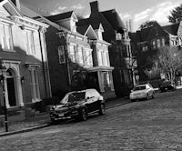 a black and white photo of a cobblestone street