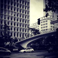 a car driving down a street in front of a tall building