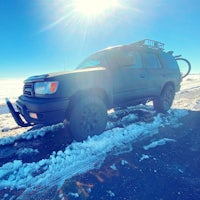a black toyota 4runner parked on a snowy road