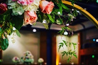 a wedding arch decorated with flowers and greenery