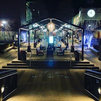 a walkway with a clock in the middle of it