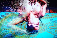 an image of a man laying on a blue floor